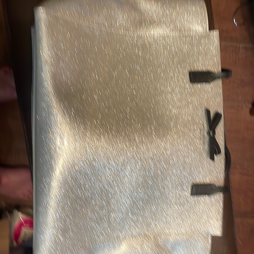Very largeSilver Metallic Kate Spade purse that would hold a tablet.Dust bag too
